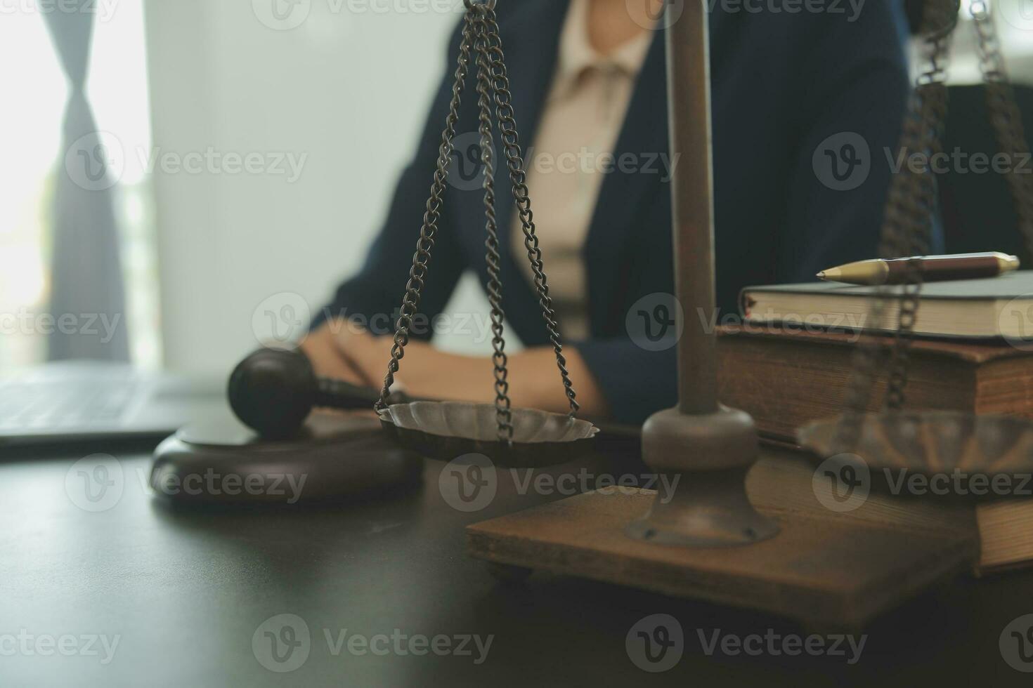 Justice and law concept.Male judge in a courtroom with the gavel, working with, computer and docking keyboard, eyeglasses, on table in morning light photo