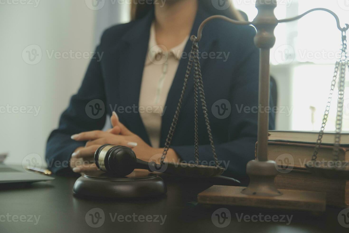 Justice and law concept.Male judge in a courtroom with the gavel, working with, computer and docking keyboard, eyeglasses, on table in morning light photo