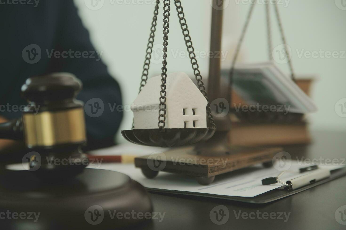 Justice and law concept.Male judge in a courtroom with the gavel, working with, computer and docking keyboard, eyeglasses, on table in morning light photo