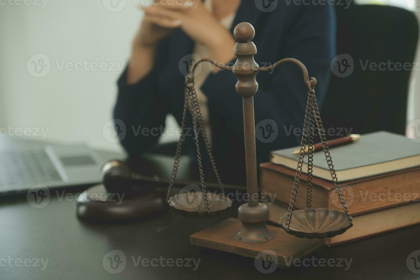 Justice and law concept.Male judge in a courtroom with the gavel, working with, computer and docking keyboard, eyeglasses, on table in morning light photo