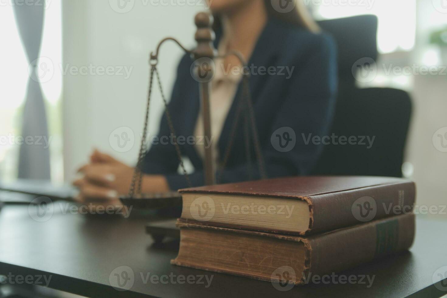 Justice and law concept.Male judge in a courtroom with the gavel, working with, computer and docking keyboard, eyeglasses, on table in morning light photo