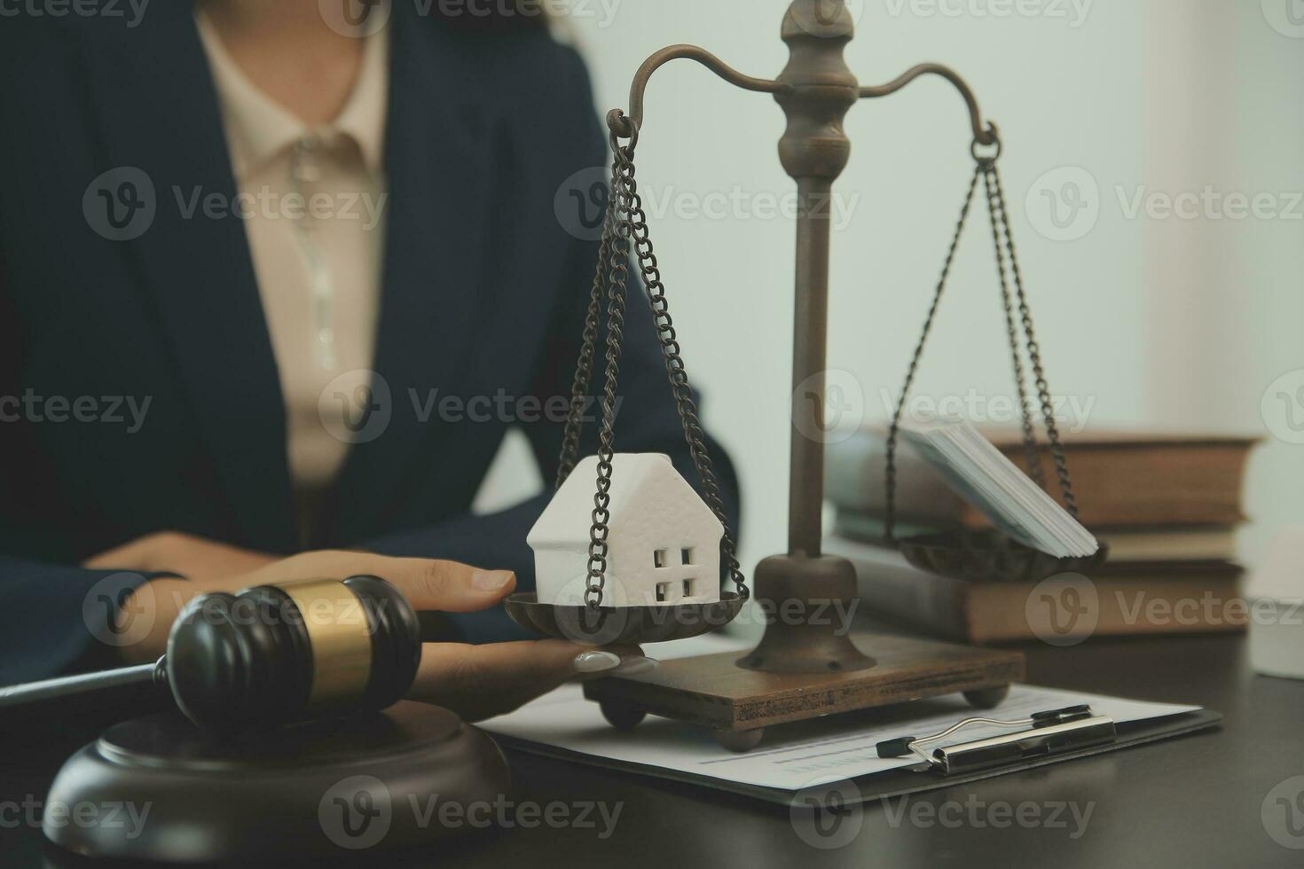 Justice and law concept.Male judge in a courtroom with the gavel, working with, computer and docking keyboard, eyeglasses, on table in morning light photo