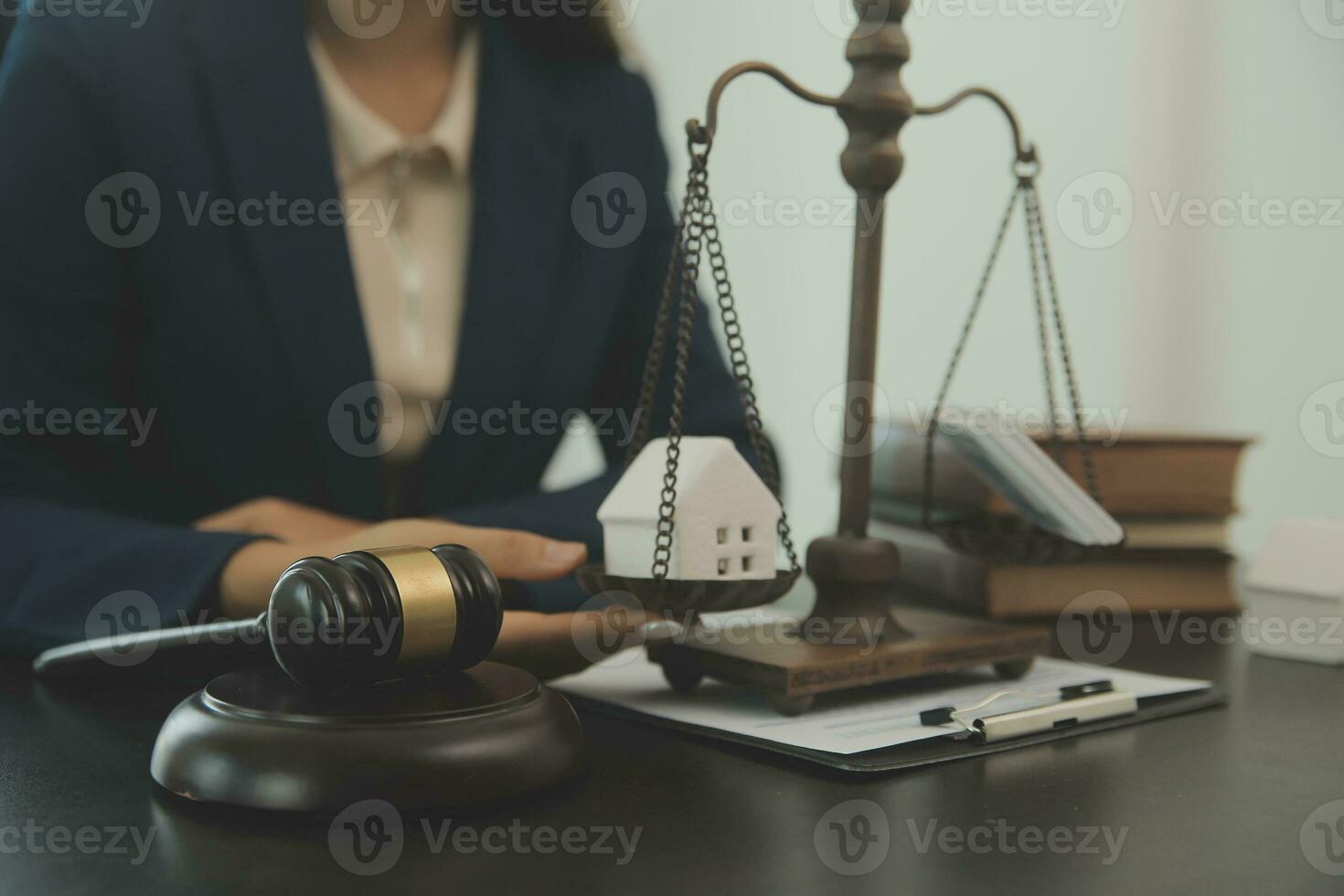 Justice and law concept.Male judge in a courtroom with the gavel, working with, computer and docking keyboard, eyeglasses, on table in morning light photo