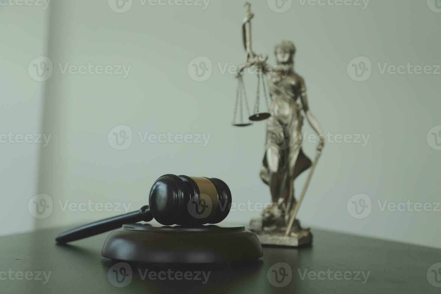 Justice and law concept.Male judge in a courtroom with the gavel, working with, computer and docking keyboard, eyeglasses, on table in morning light photo