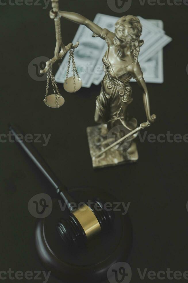 Justice and law concept.Male judge in a courtroom with the gavel, working with, computer and docking keyboard, eyeglasses, on table in morning light photo