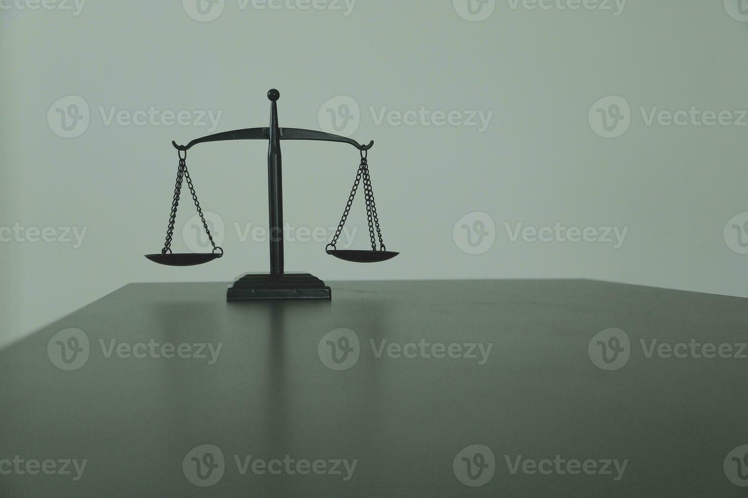 Justice and law concept.Male judge in a courtroom with the gavel, working with, computer and docking keyboard, eyeglasses, on table in morning light photo