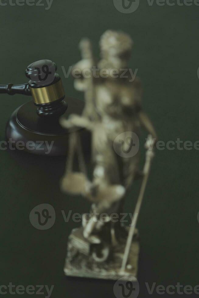 Justice and law concept.Male judge in a courtroom with the gavel, working with, computer and docking keyboard, eyeglasses, on table in morning light photo