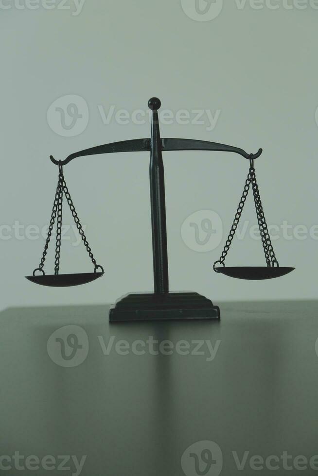 Justice and law concept.Male judge in a courtroom with the gavel, working with, computer and docking keyboard, eyeglasses, on table in morning light photo