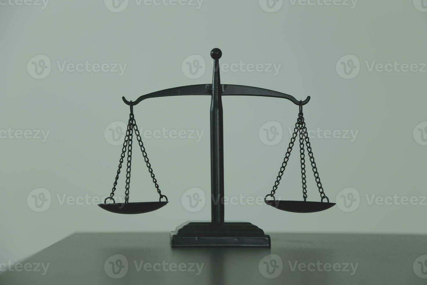 Justice and law concept.Male judge in a courtroom with the gavel, working with, computer and docking keyboard, eyeglasses, on table in morning light photo
