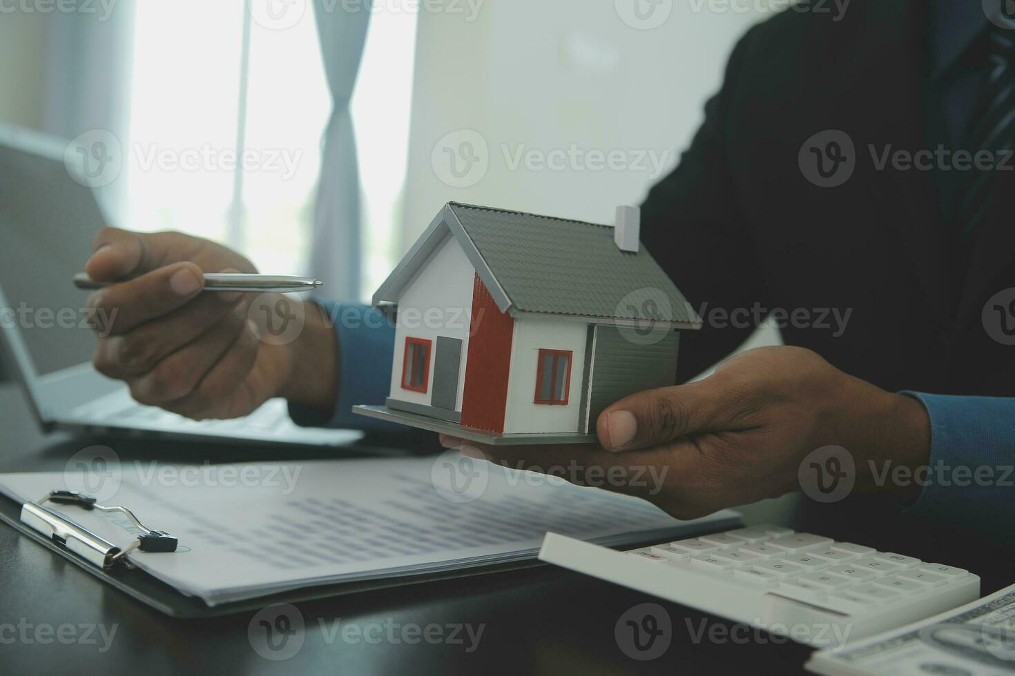 House model with real estate agent and customer discussing for contract to buy house, insurance or loan real estate,real estate concept. photo
