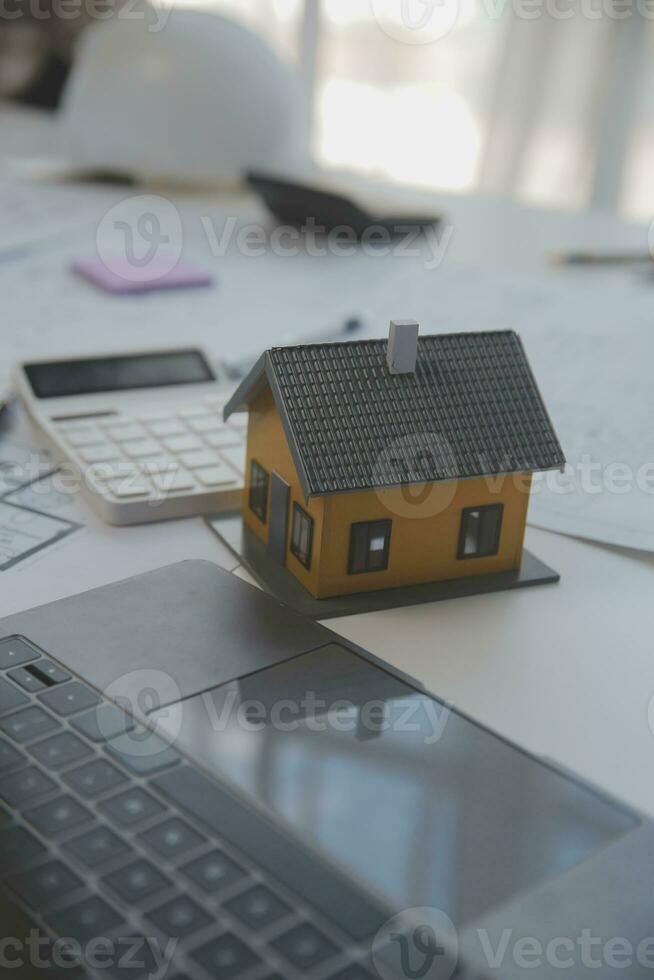 Construction and structure concept of engineer working drawing on blueprint meeting for project working with partner on model building and engineering tools in working site, construction concept. photo