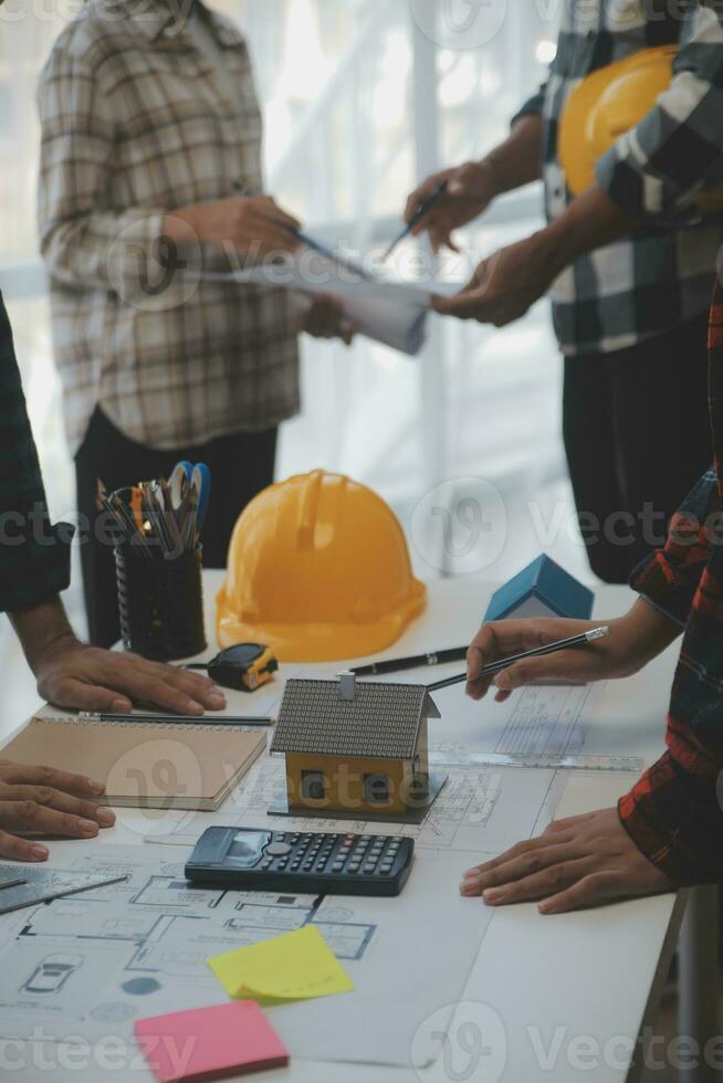 Construction and structure concept of engineer working drawing on blueprint meeting for project working with partner on model building and engineering tools in working site, construction concept. photo
