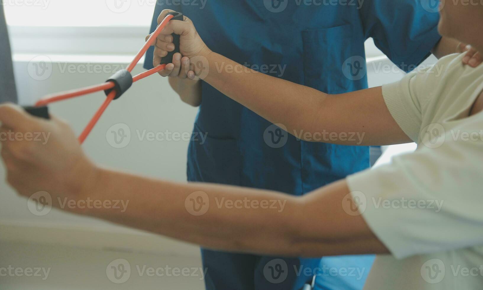 Patient doing some special exercises under supervision in a room photo