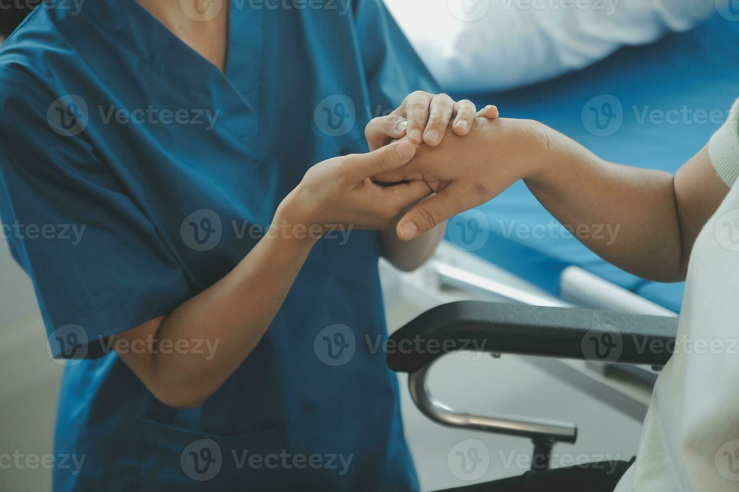 young asian physical therapist working with senior woman on walking with a walker photo
