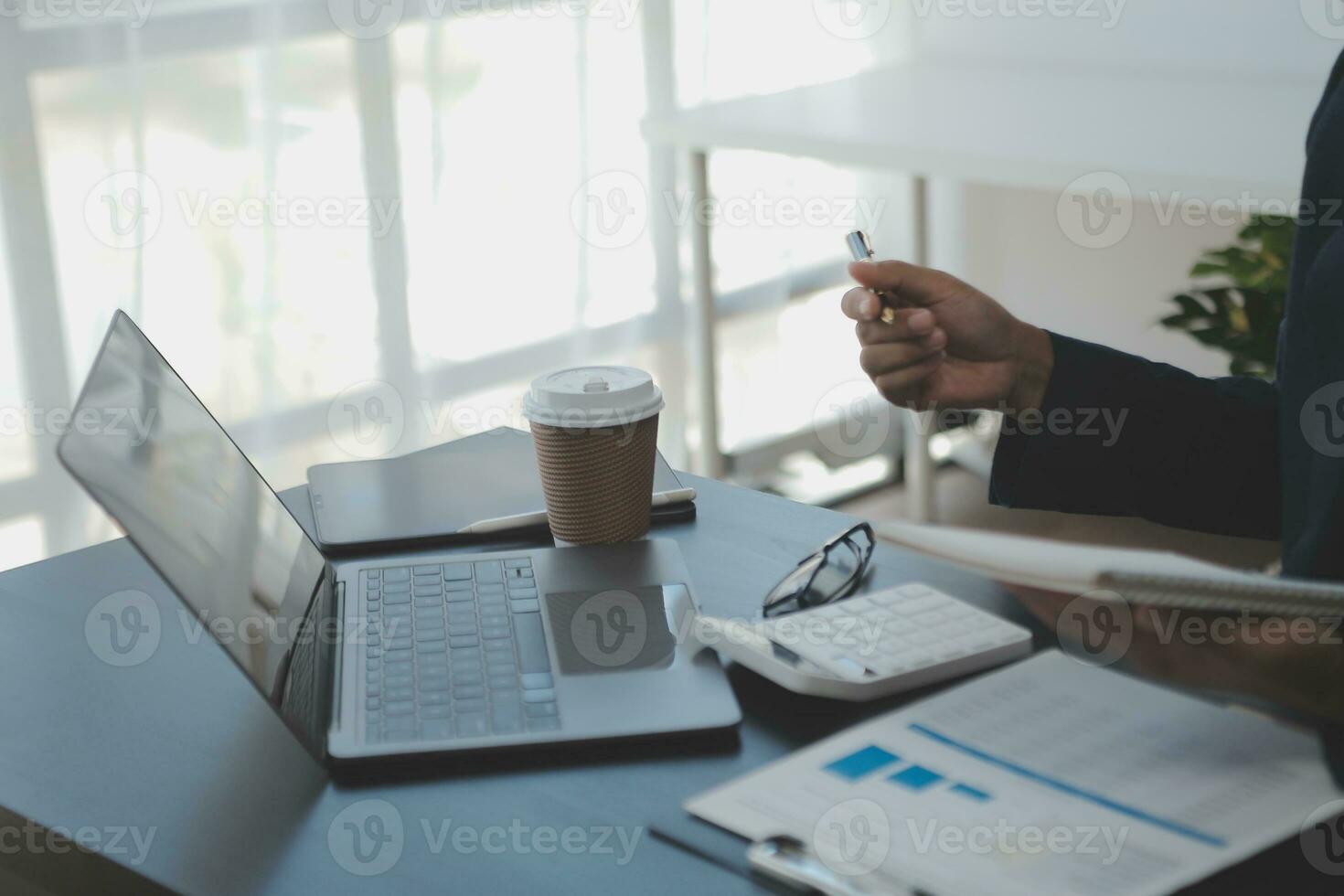 Young adult happy smiling Hispanic Asian student wearing headphones talking on online chat meeting using laptop in university campus or at virtual office. College female student learning remotely. photo