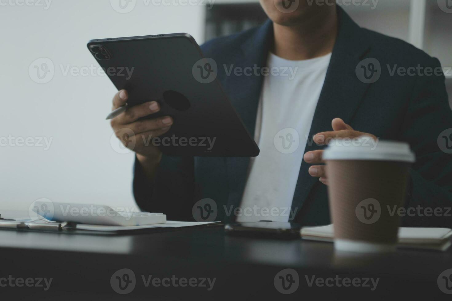 Young adult happy smiling Hispanic Asian student wearing headphones talking on online chat meeting using laptop in university campus or at virtual office. College female student learning remotely. photo