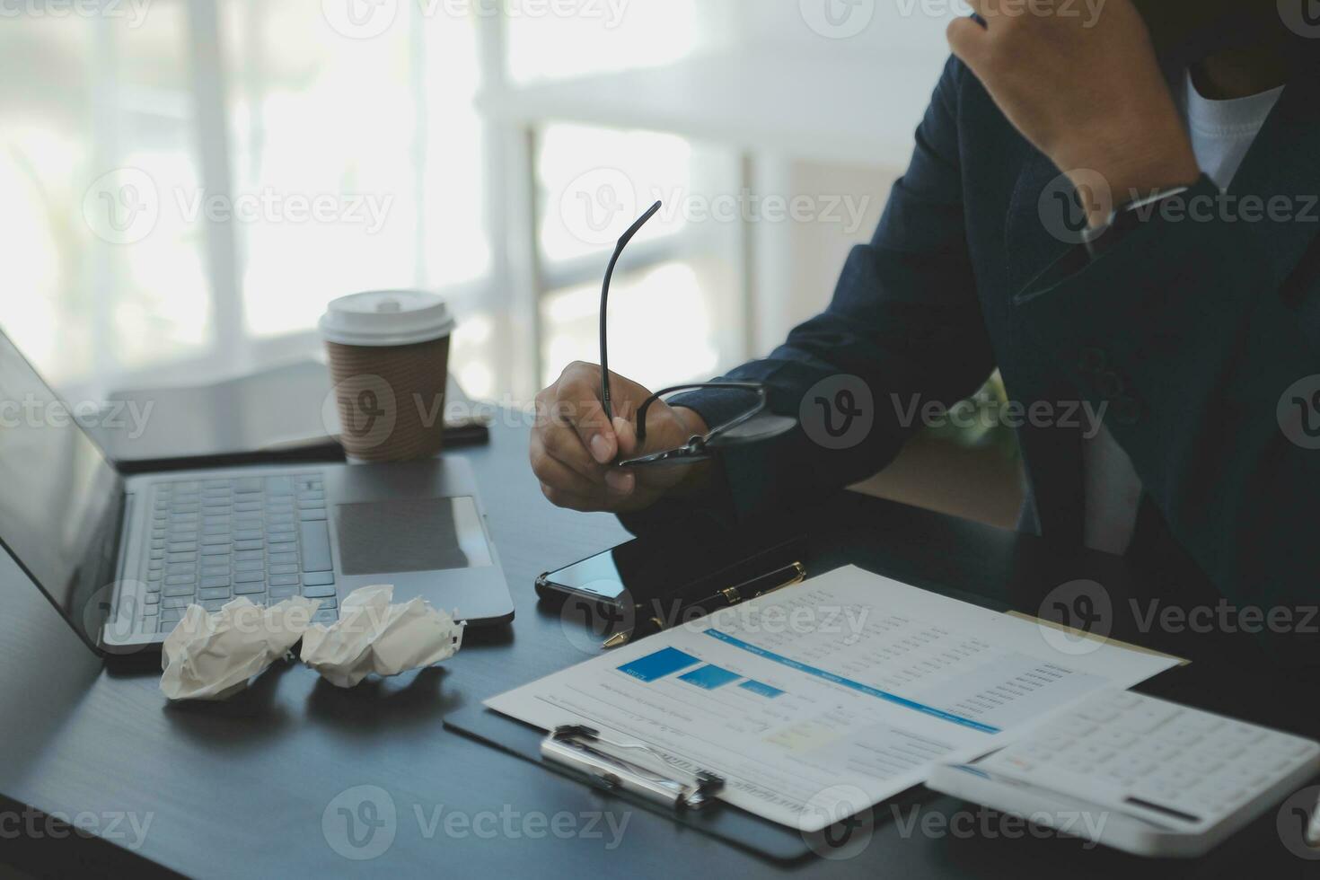 Young adult happy smiling Hispanic Asian student wearing headphones talking on online chat meeting using laptop in university campus or at virtual office. College female student learning remotely. photo