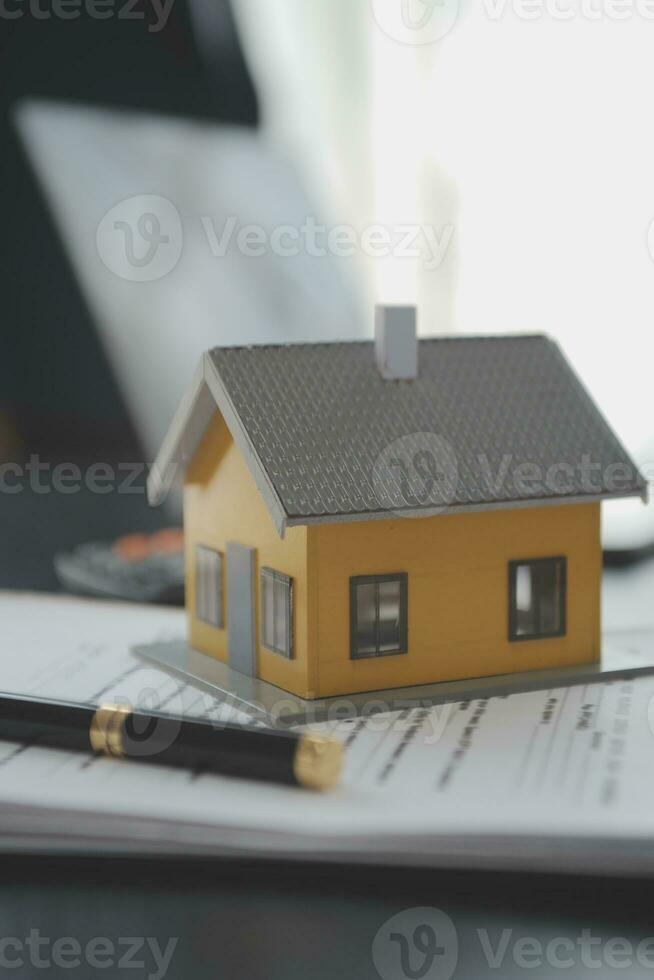 Female woman hands holding home model, small miniature white toy house. Mortgage property insurance dream moving home and real estate concept photo