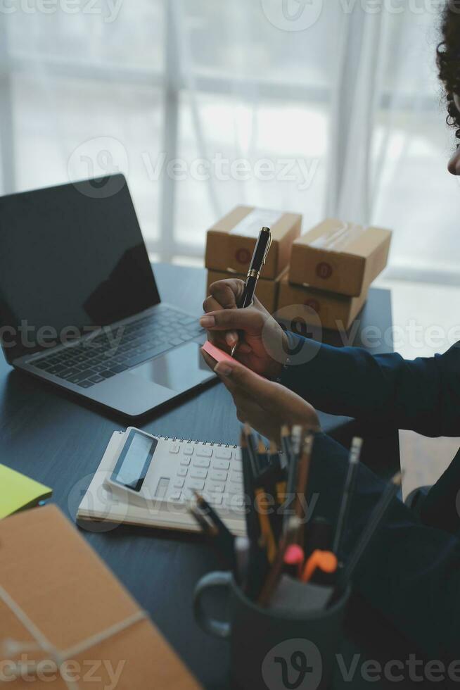 Business woman start up small business entrepreneur SME success .freelance woman working at home with Online Parcel delivery. SME and packaging deliveryconcept photo
