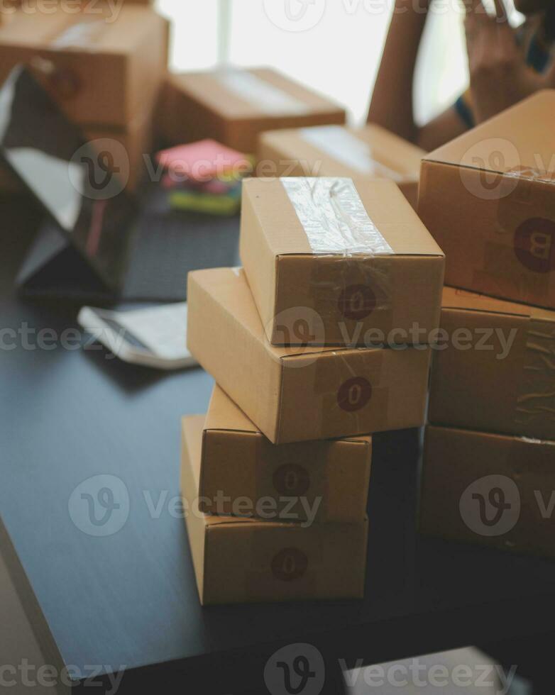 Business woman start up small business entrepreneur SME success .freelance woman working at home with Online Parcel delivery. SME and packaging deliveryconcept photo