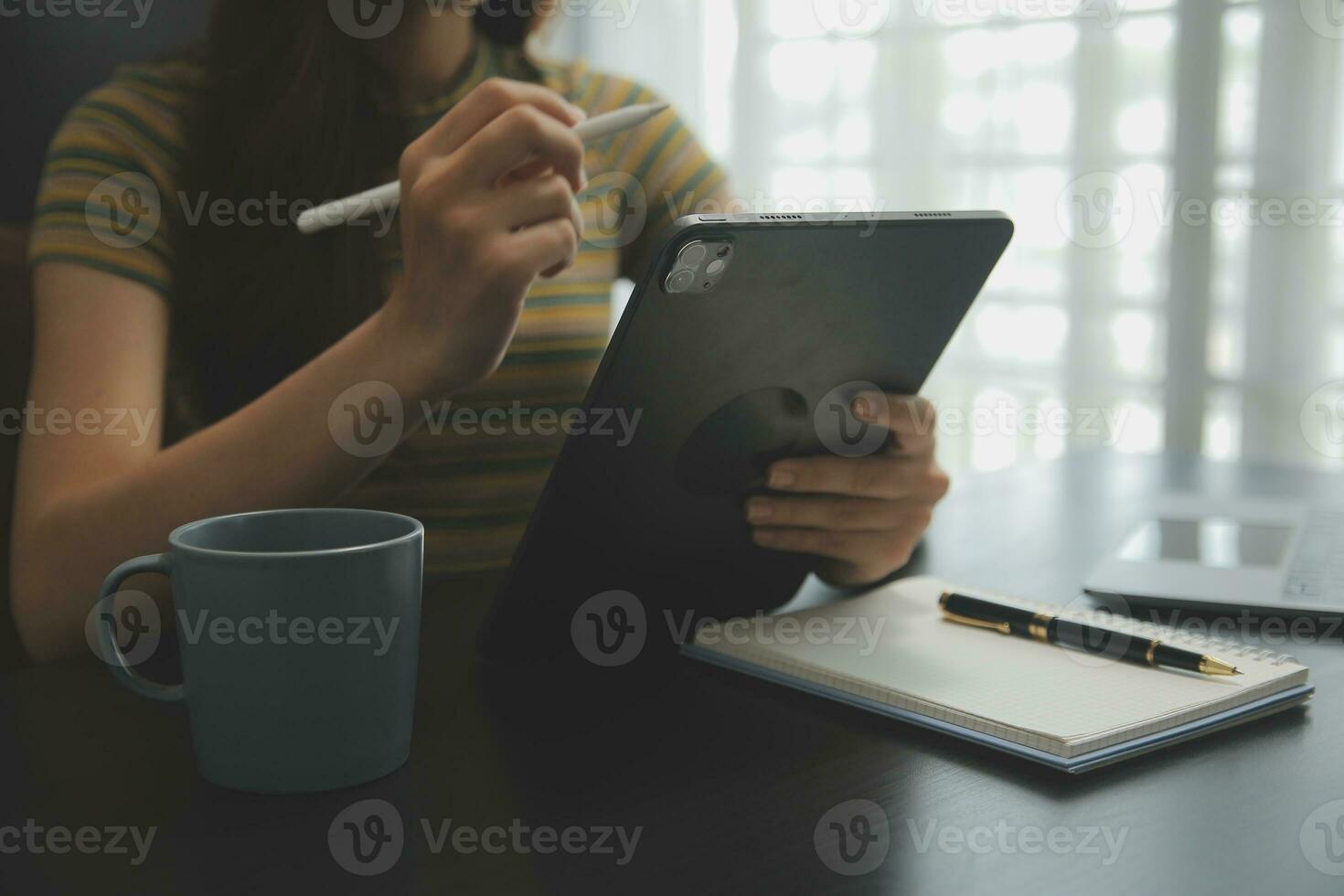 Shot of a asian young business Female working on laptop in her workstation. photo
