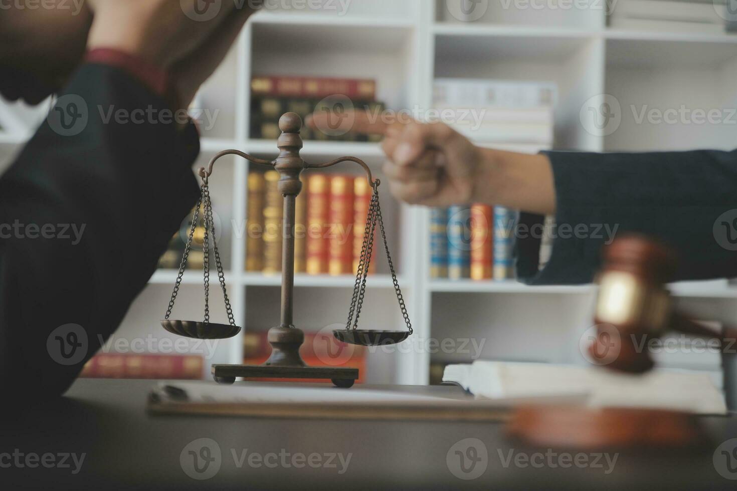 Justice and law concept.Male judge in a courtroom with the gavel, working with, computer and docking keyboard, eyeglasses, on table in morning light photo