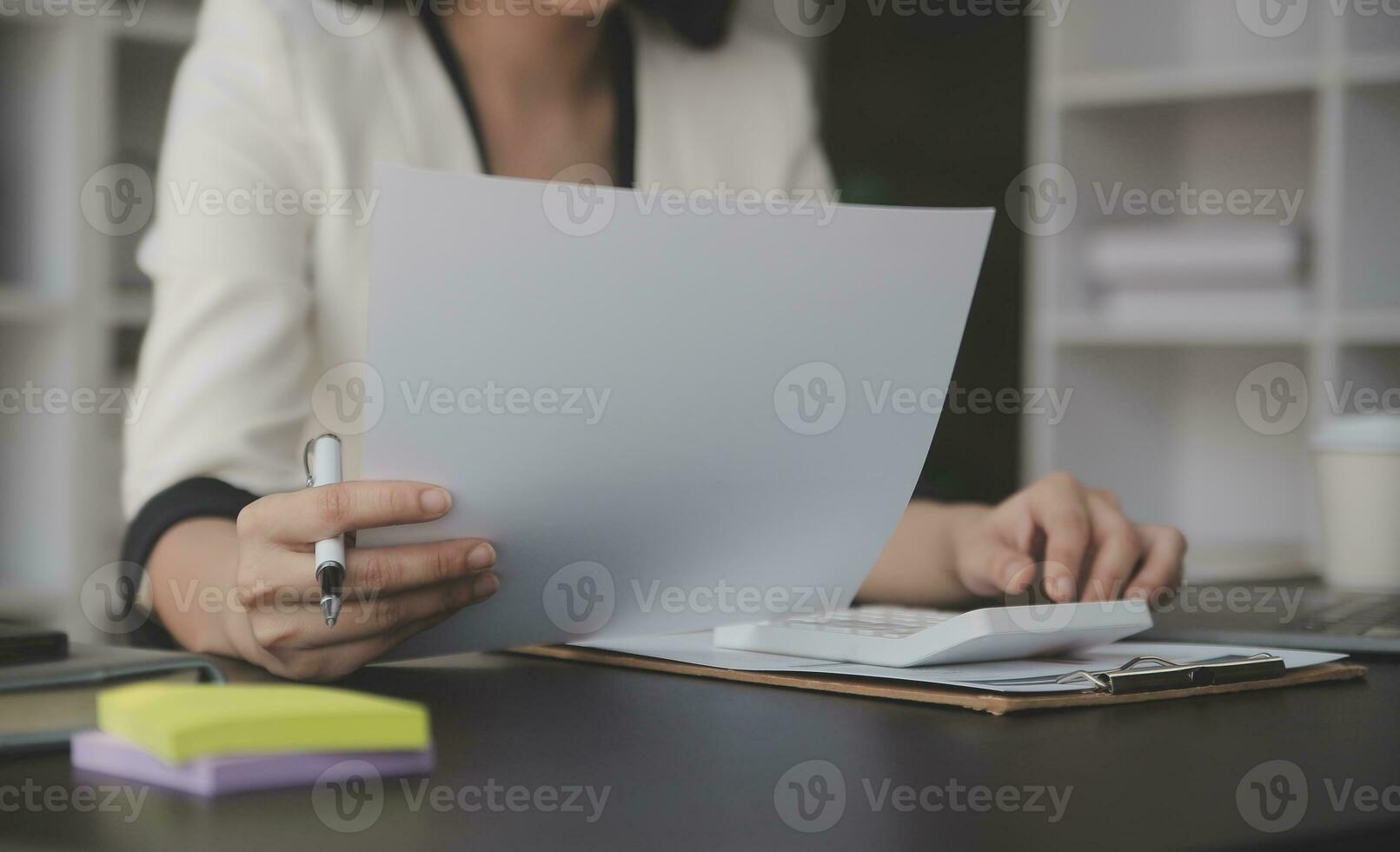 Audit concept,Administrator business man financial inspector and secretary making report calculating balance. Internal Revenue Service checking document. photo