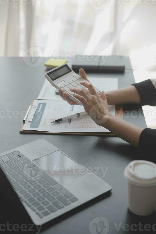 Audit concept,Administrator business man financial inspector and secretary making report calculating balance. Internal Revenue Service checking document. photo