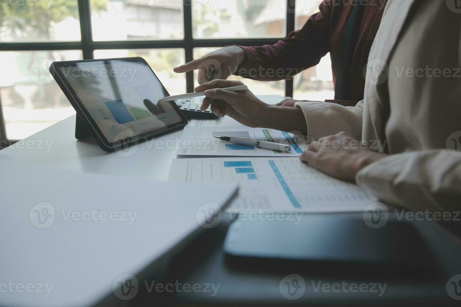 Asian Business woman using calculator and laptop for doing math finance on an office desk, tax, report, accounting, statistics, and analytical research concept photo