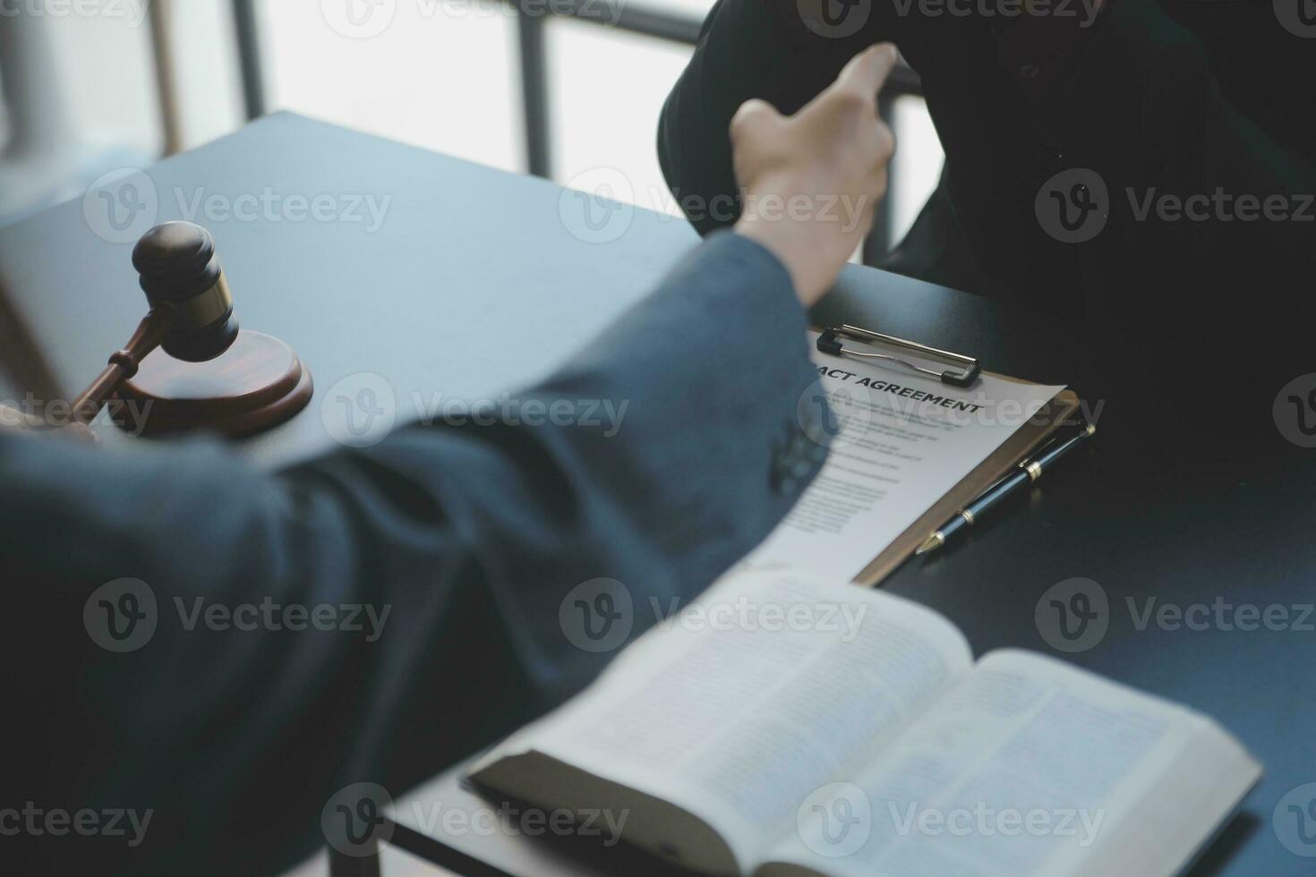 Male lawyer working with contract papers and wooden gavel on tabel in courtroom. justice and law ,attorney, court judge, concept. photo