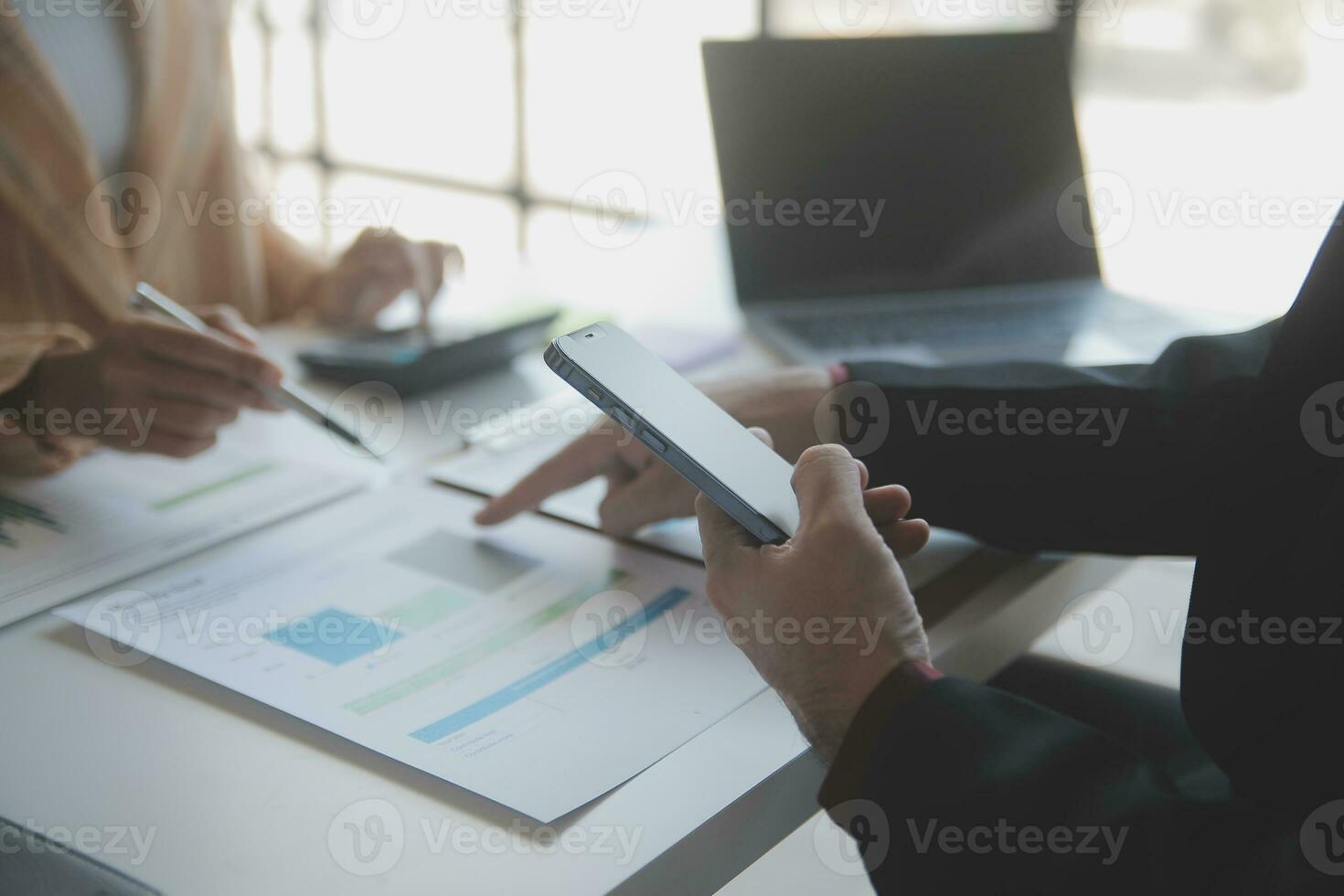 Asian Business woman using calculator and laptop for doing math finance on an office desk, tax, report, accounting, statistics, and analytical research concept photo