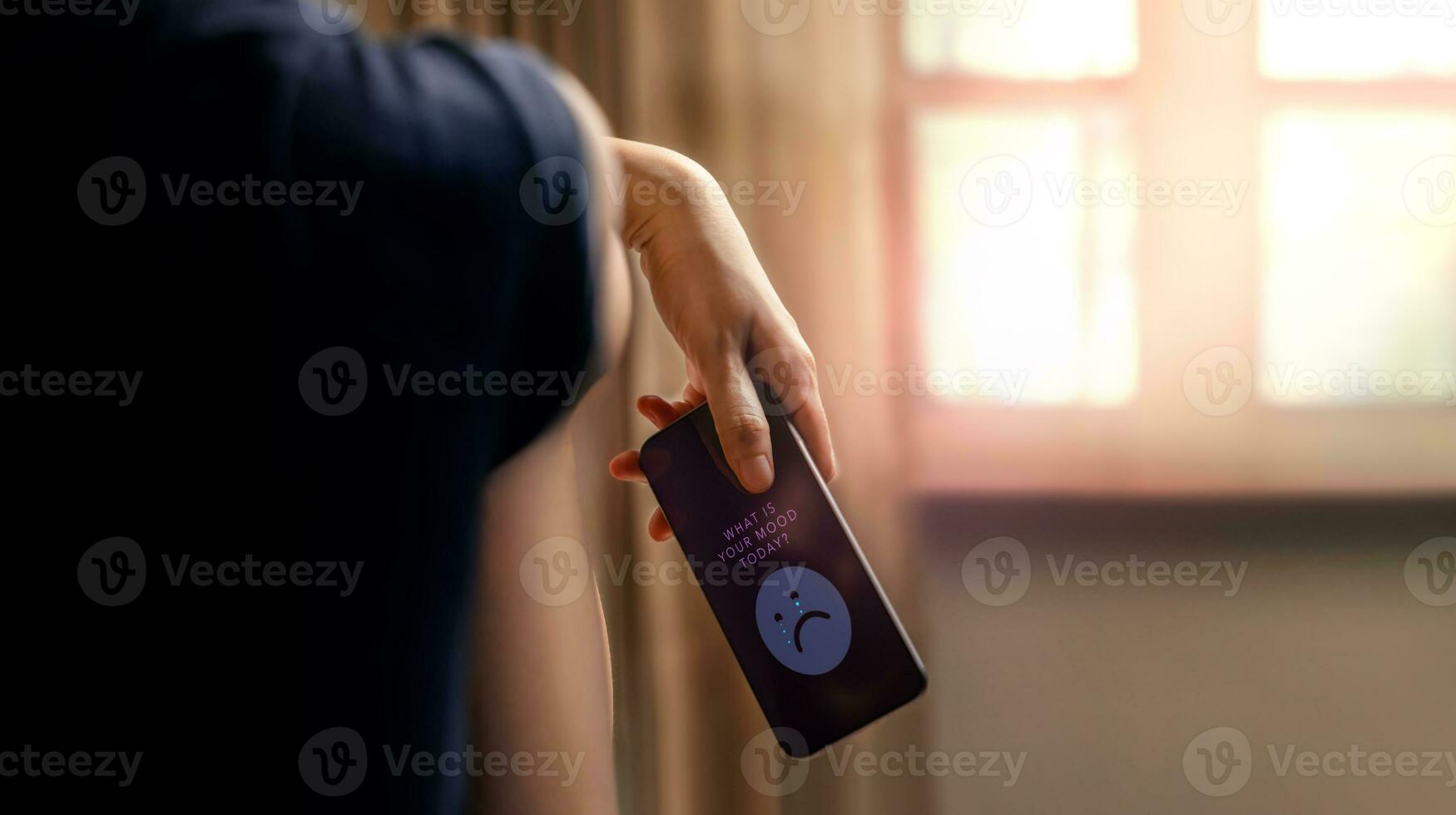 Social Media affect a Physical and Mental Health Concept. a Stress, Anxiety, Depression Women sitting by the Window in Bedroom with her Mobile Phone. Social Bullying photo