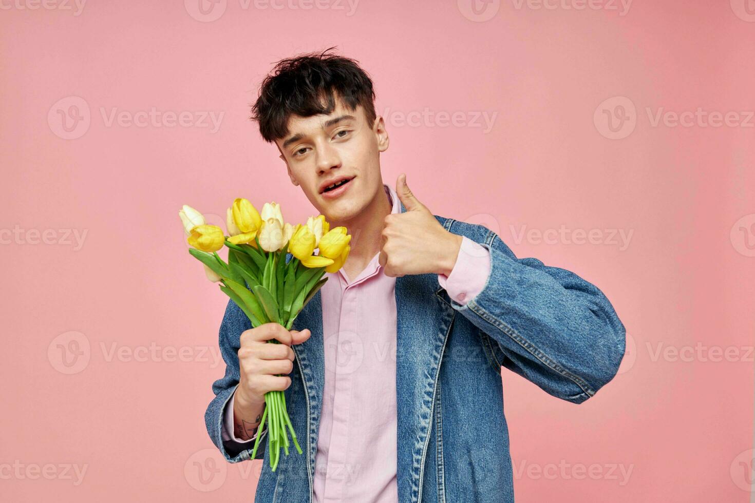 pretty man in a denim jacket with a bouquet of flowers a gift romance holiday unaltered photo