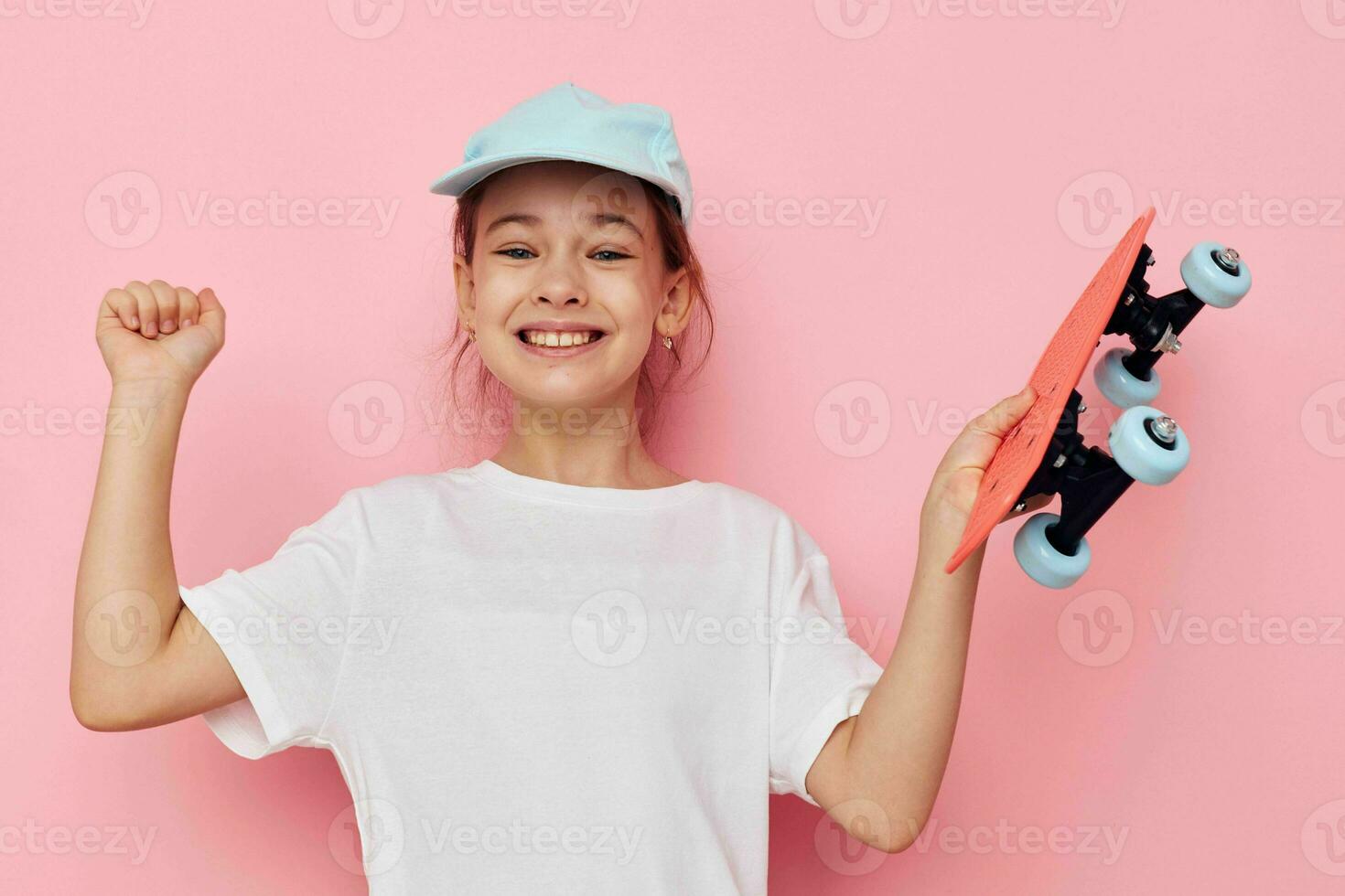 Portrait of happy smiling child girl with a skateboard in hand isolated background photo