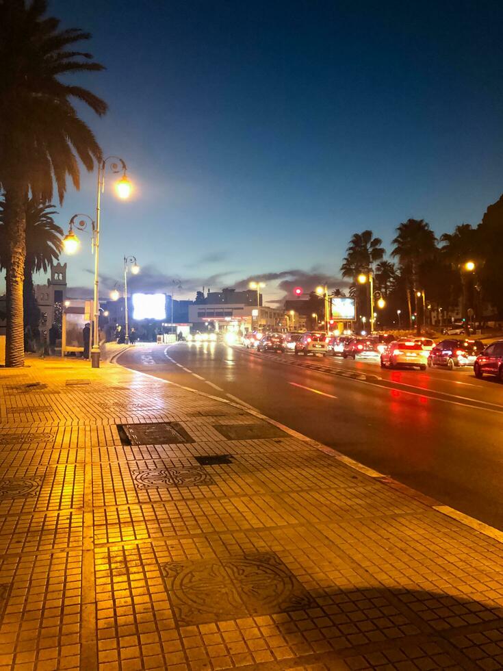 Road and sidewalk between night lighting photo