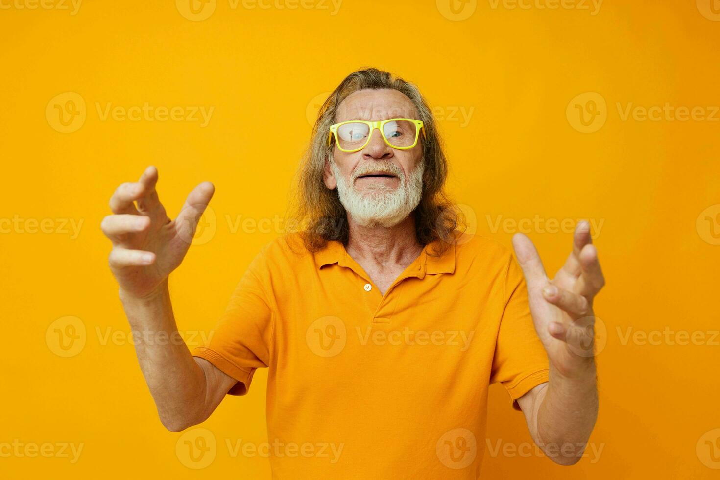 Portrait of happy senior man hand gestures emotions yellow glasses isolated background photo