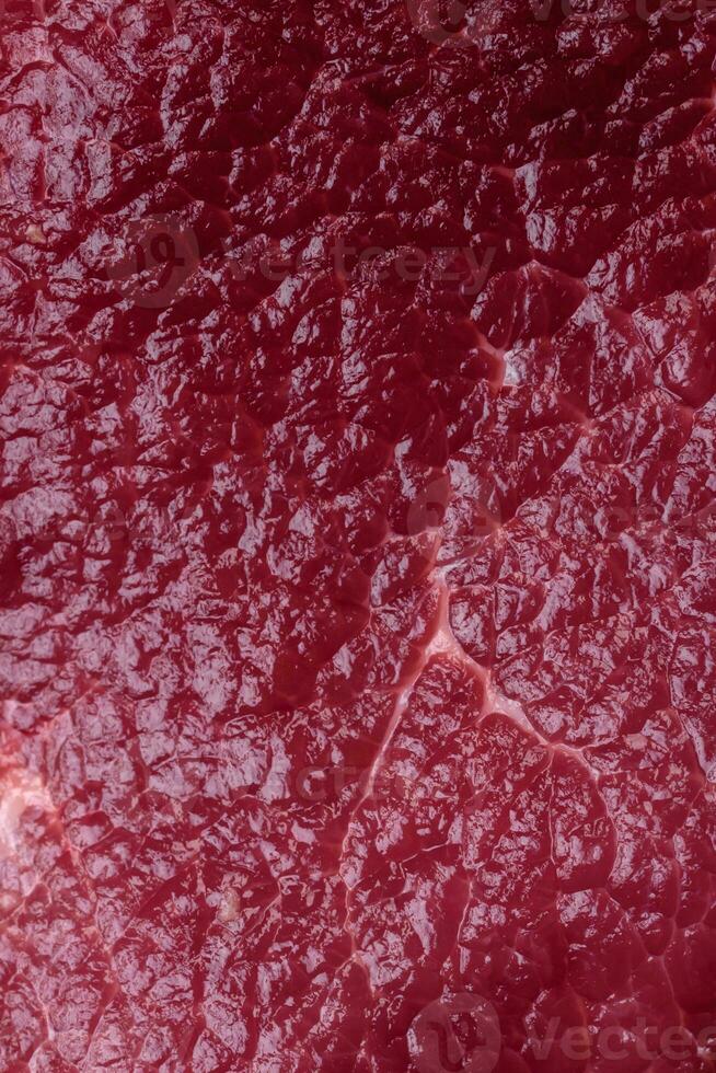 Juicy raw beef with spices, salt and herbs on a dark concrete background photo