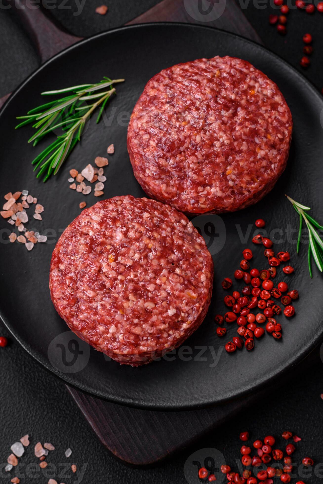 Fresh raw ground beef burger patty with salt and spices 25004450 Stock