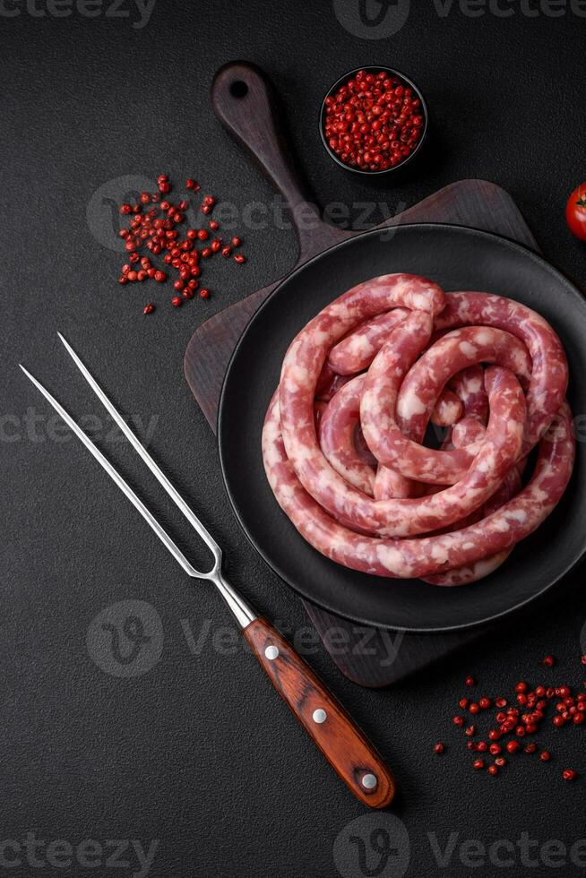 Raw sausages from pork or beef with salt, spices and herbs photo