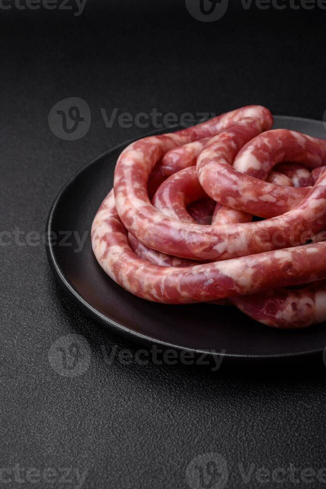 Raw sausages from pork or beef with salt, spices and herbs photo