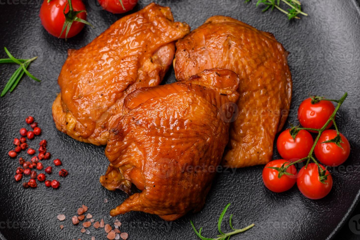 Delicious fried or smoked chicken thighs grilled with spices and herbs photo