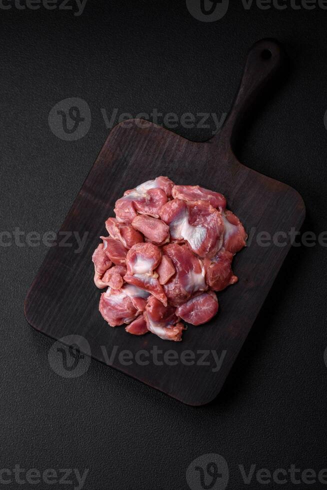 Raw chicken or turkey gizzards with salt, spices and herbs photo