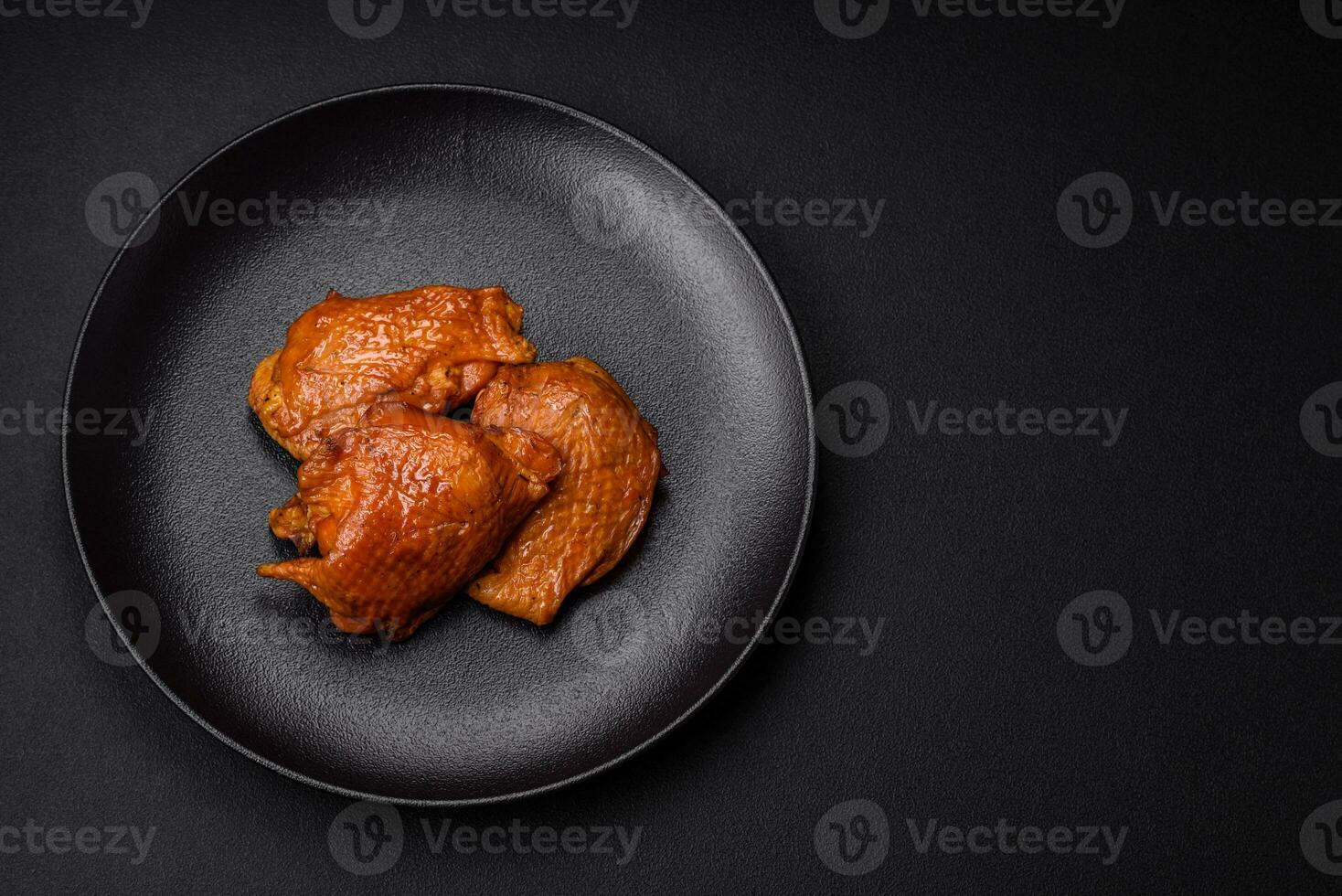 Delicious fried or smoked chicken thighs grilled with spices and herbs photo