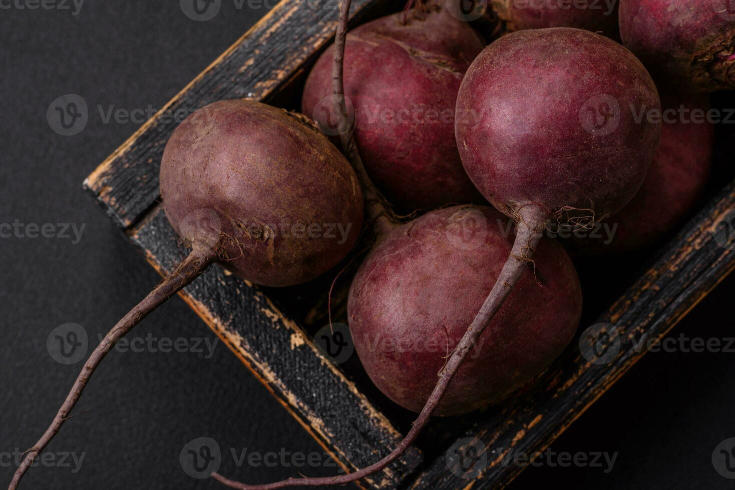 Fresh raw beetroot in the form of tubers on a textured concrete background photo