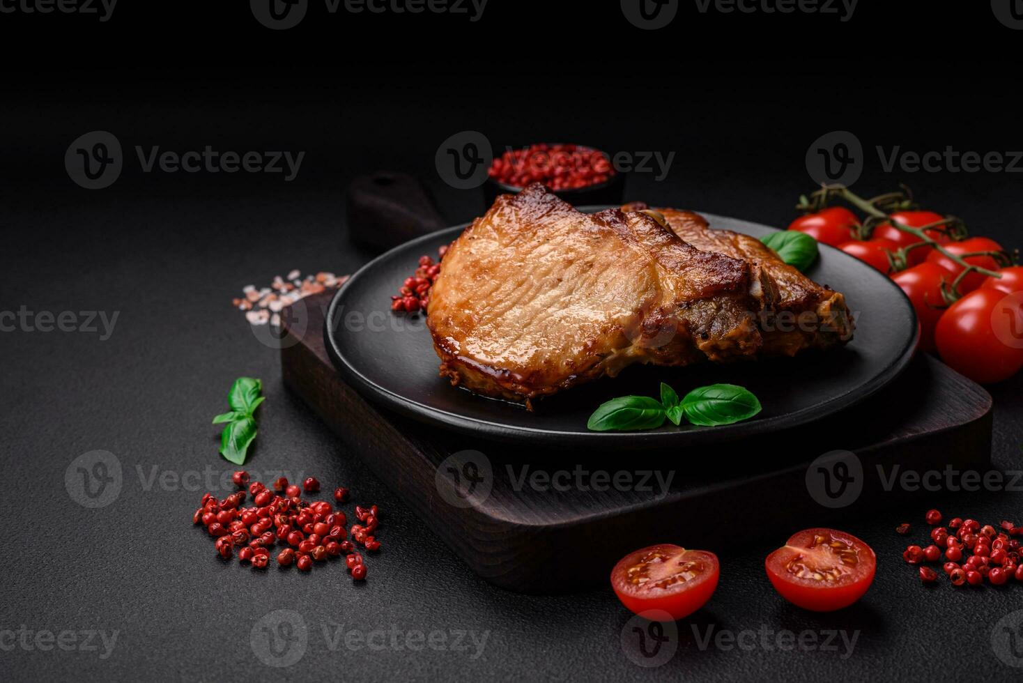 Delicious juicy pork or beef steak with salt, spices and herbs photo