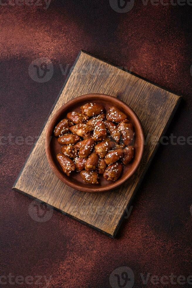 Chicken hearts fried in soy sauce with salt and spices in a plate photo