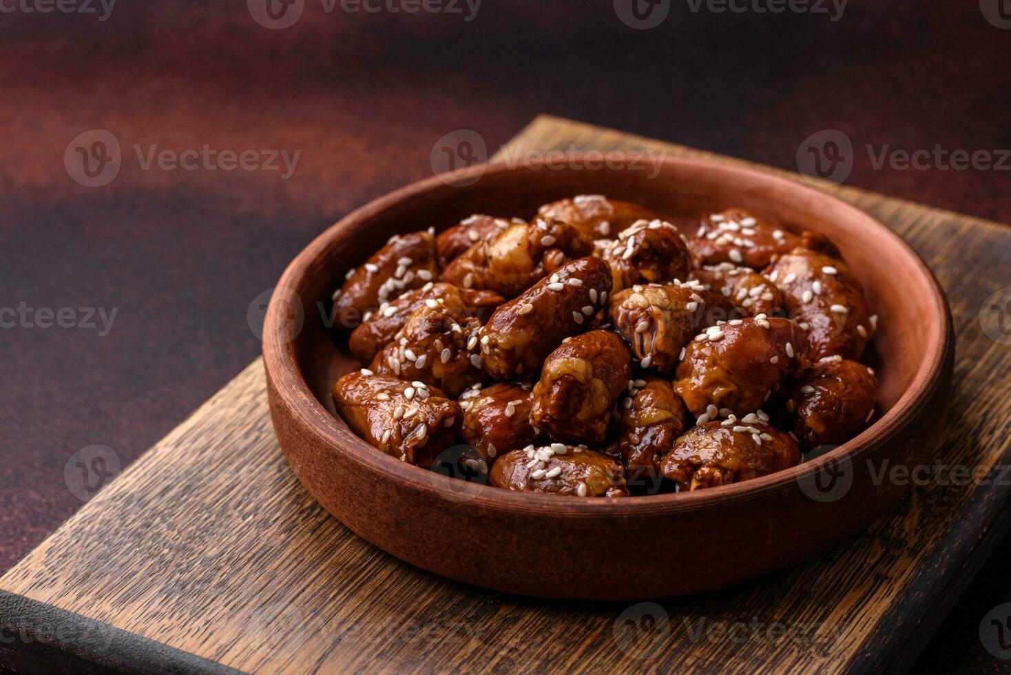 Chicken hearts fried in soy sauce with salt and spices in a plate photo