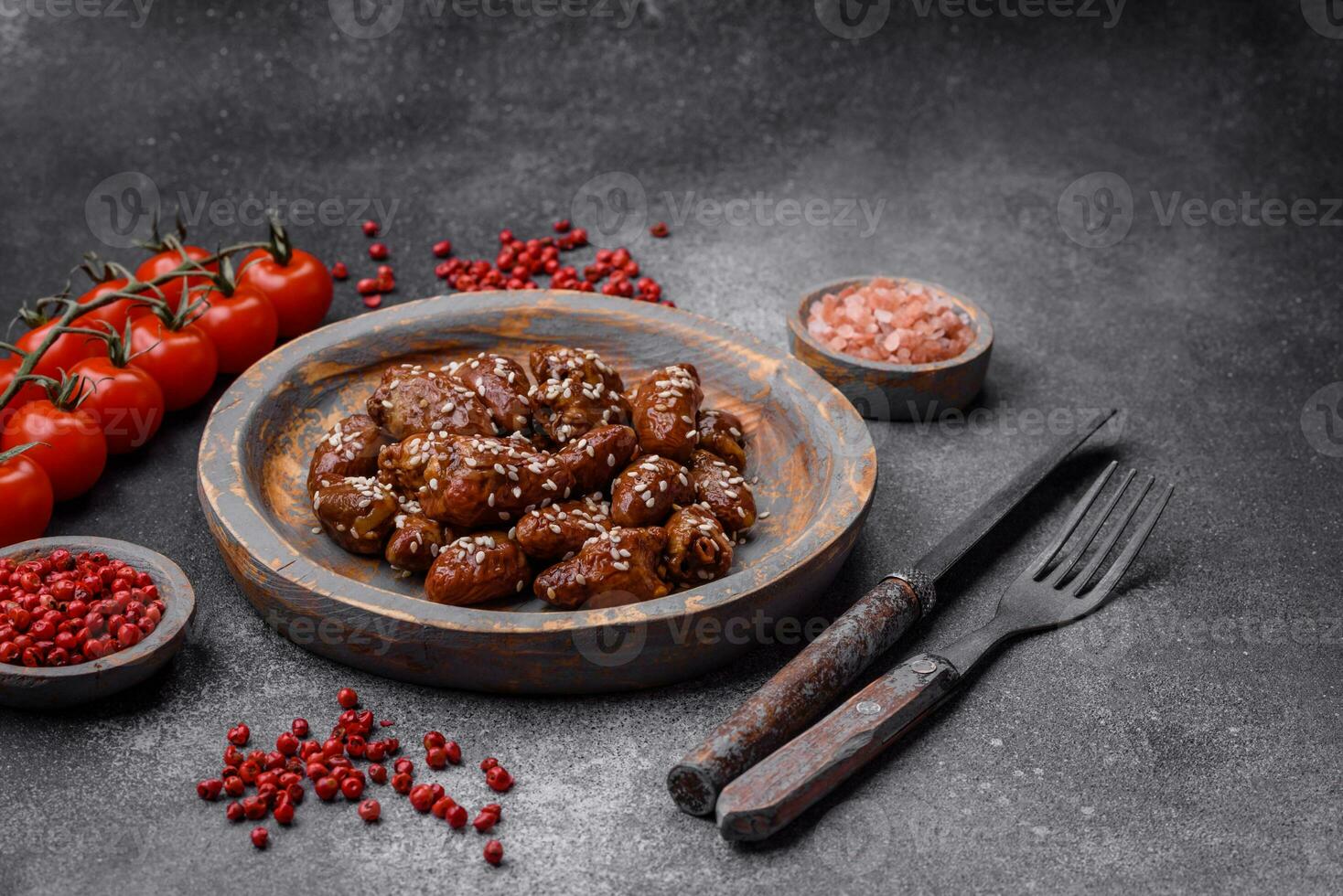 Chicken hearts fried in soy sauce with salt and spices in a plate photo