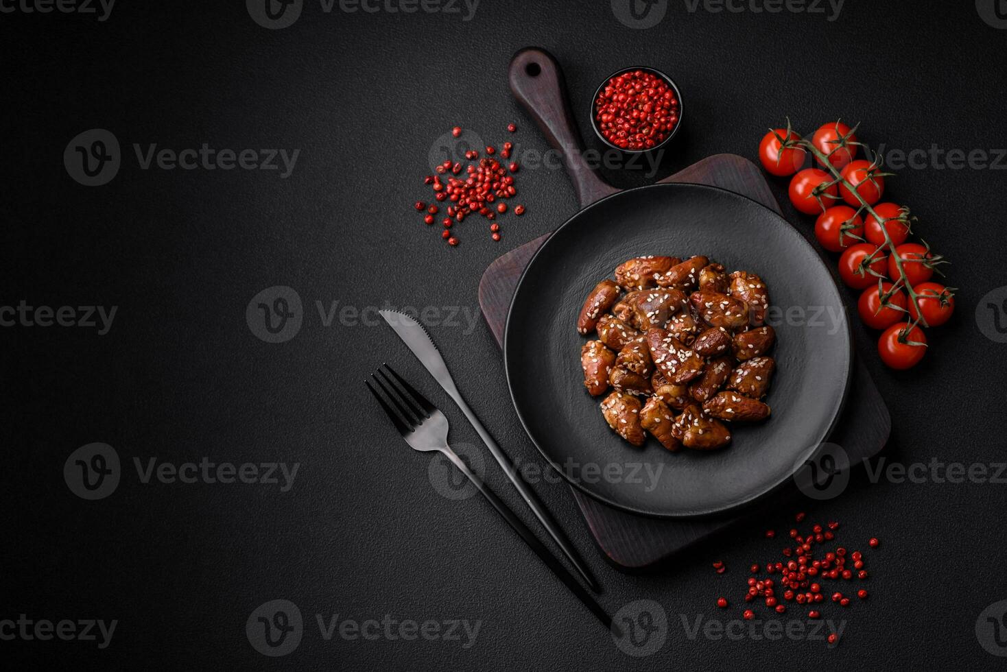 Chicken hearts fried in soy sauce with salt and spices in a plate photo