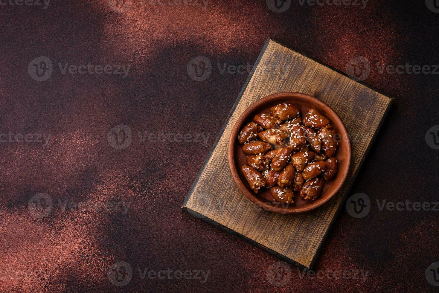 Chicken hearts fried in soy sauce with salt and spices in a plate photo